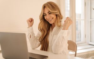 woman sitting at laptop working on her website